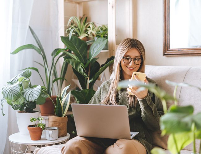 we-man-with-mobile-cell-phone-and-laptop-at-home-2022-11-14-16-43-24-utc